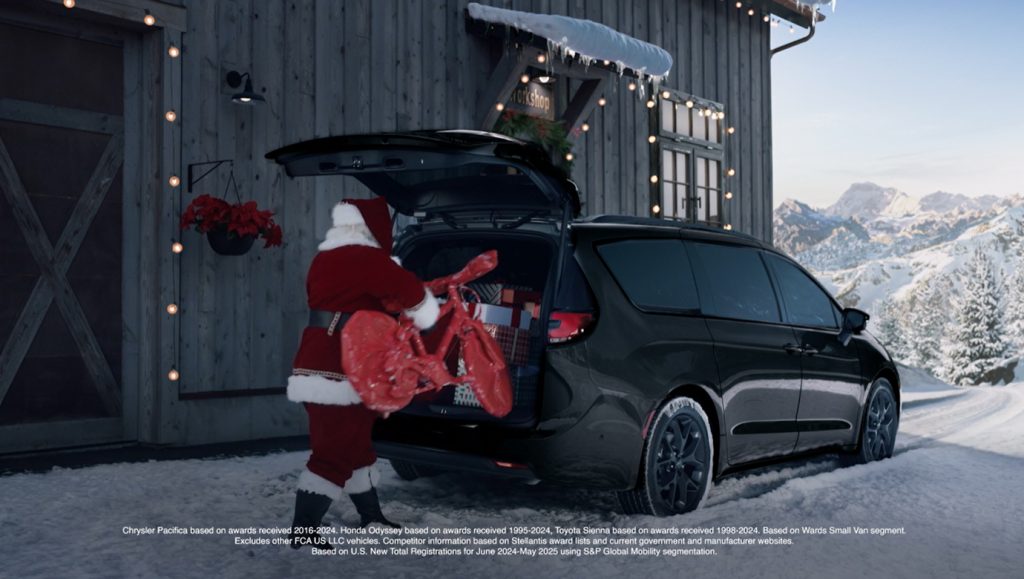 Santa is filling the trunk of a Pacifica with presents.