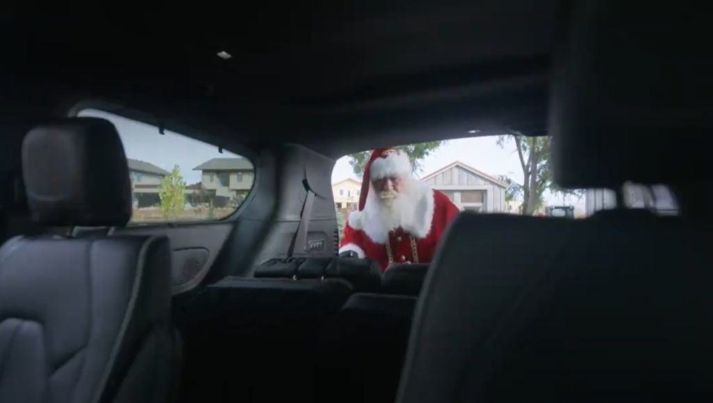 Santa folding down the rear seats in a Pacifica